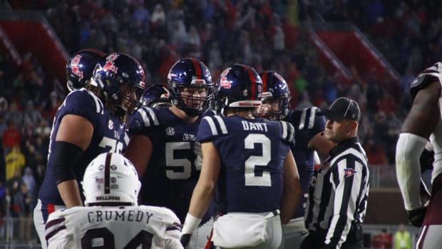 Jaxson Dart Ole Miss huddle navy